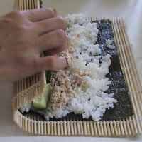 Sushi being rolled